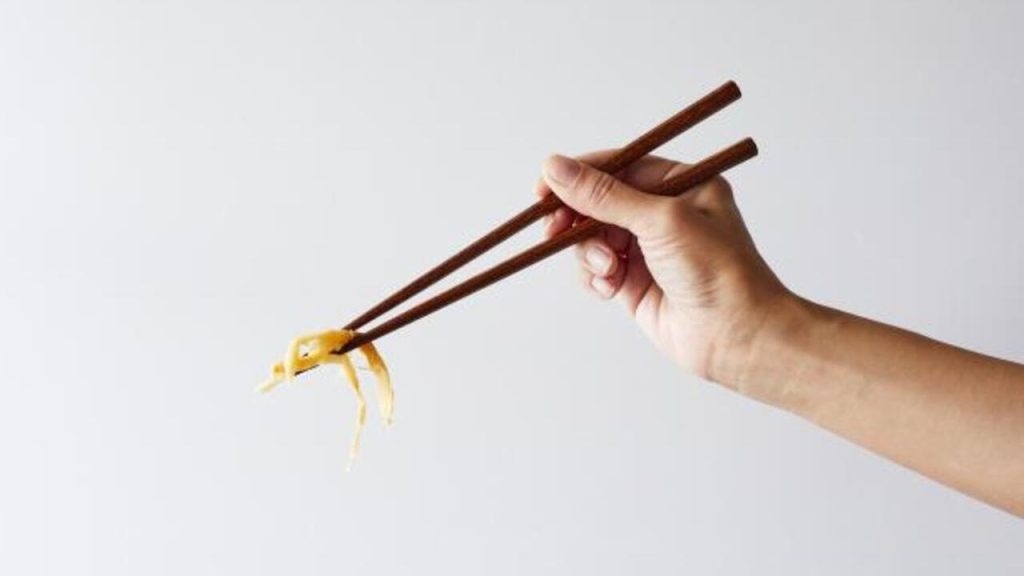 using chopstick to eat